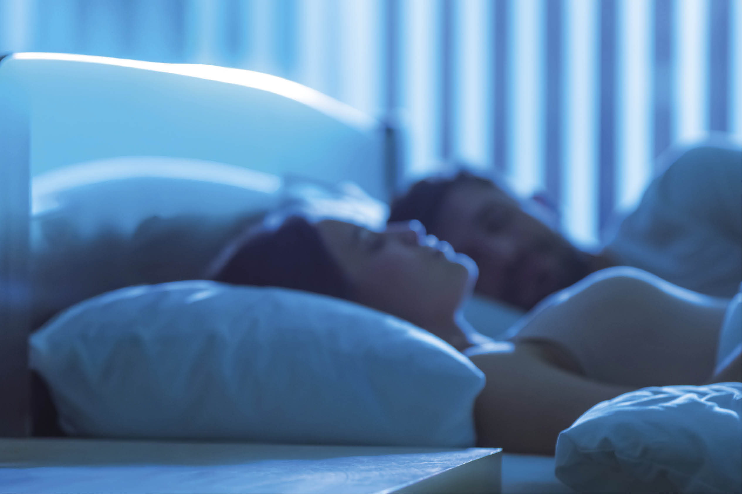 The lamp on the background of the sleeping couple. night time