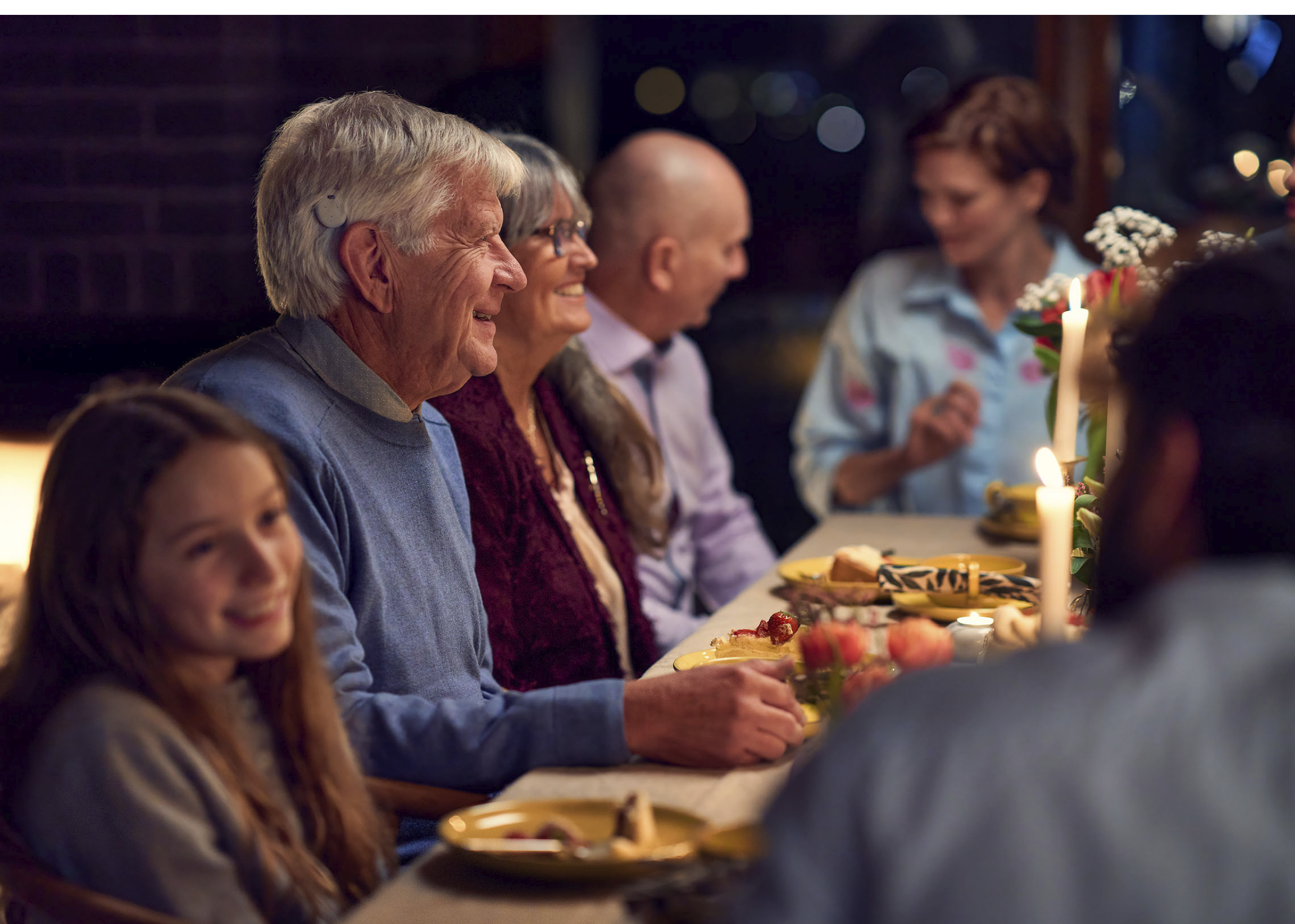 A group of people are sitting around a table, enjoying a meal together. AI generated content