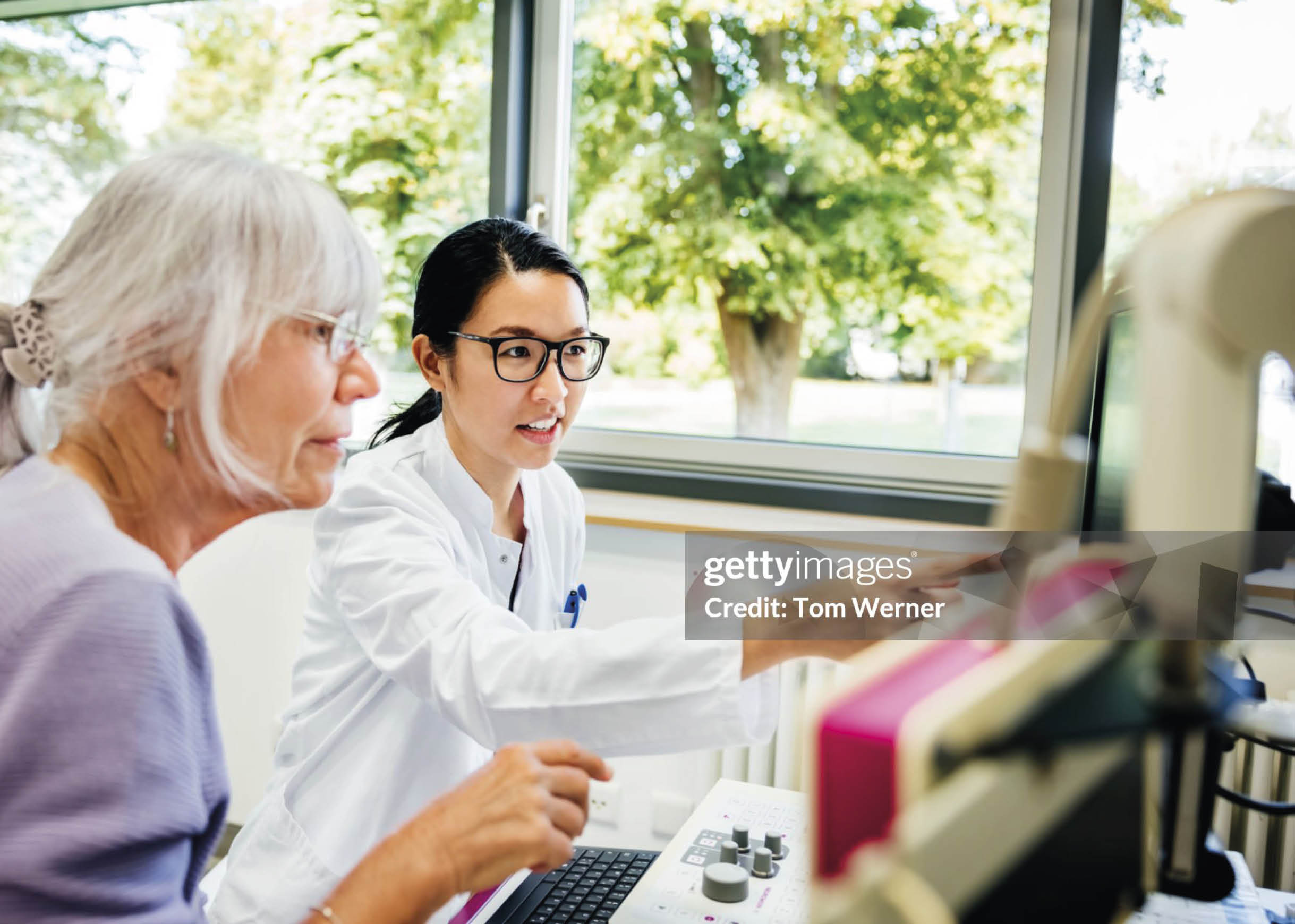 A woman wearing glasses and a white lab coat is using a computer. AI generated content