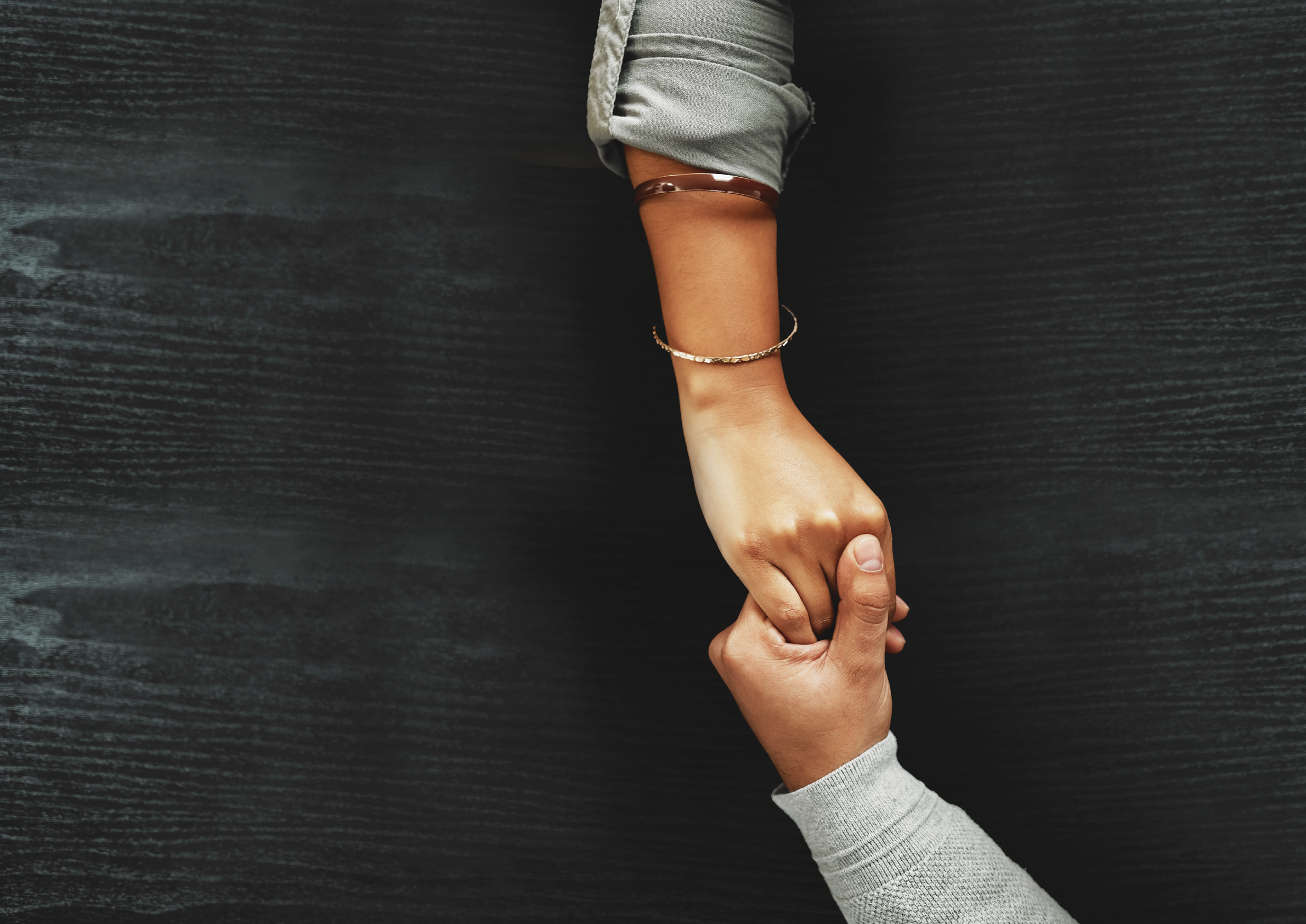 High angle shot of an unrecognizable couple compassionately holding hands at a table